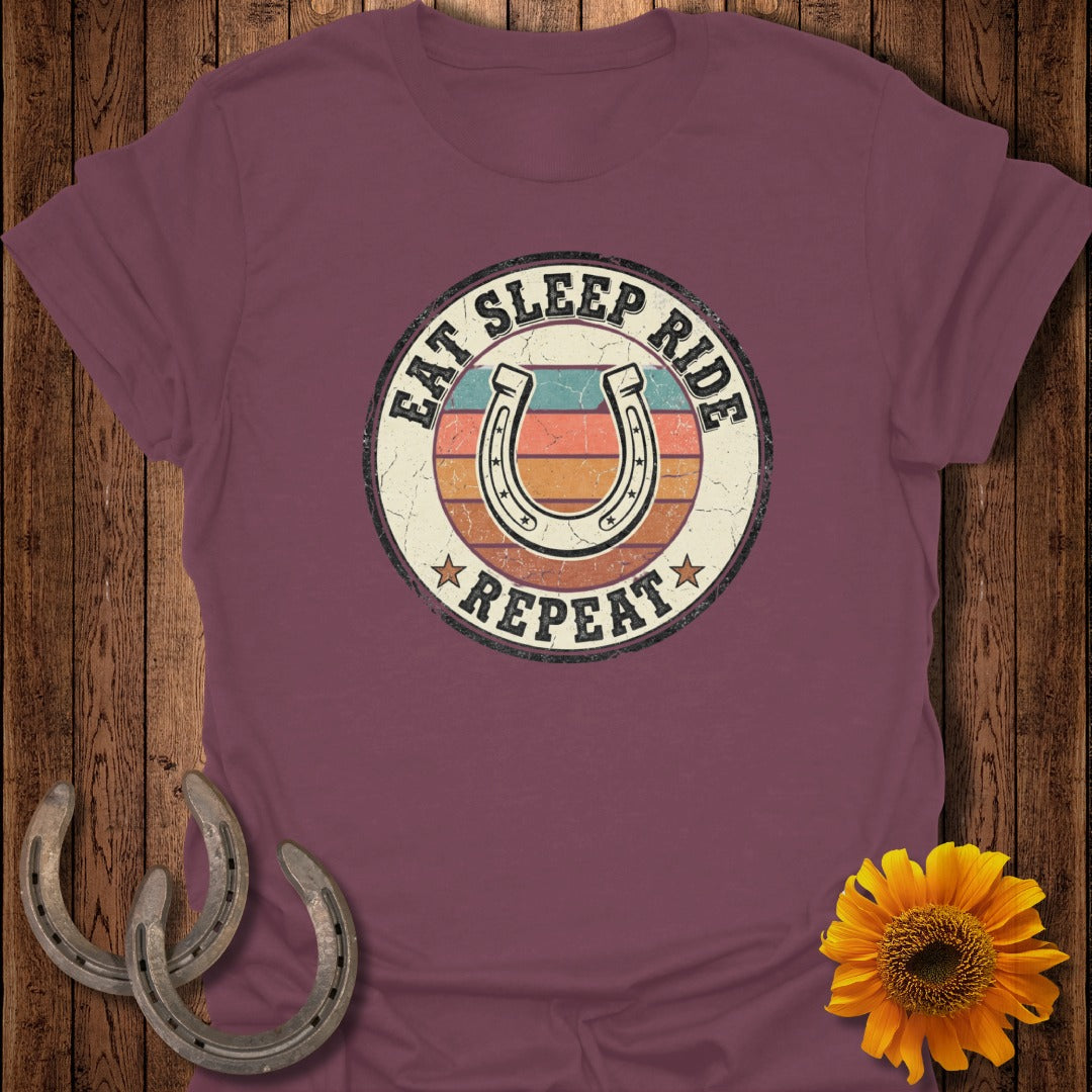Burgundy t-shirt with "Eat Sleep Ride Repeat" and horseshoe graphic.