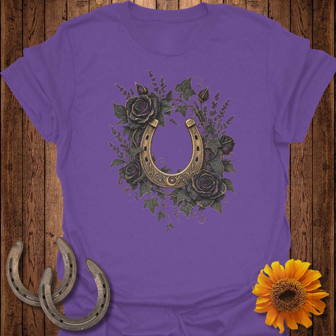 Purple t-shirt with a golden horseshoe surrounded by dark roses and greenery.