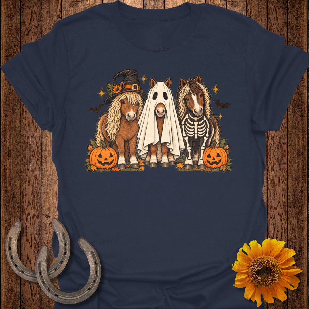 Three ponies dressed for Halloween with pumpkins, bats, and stars.