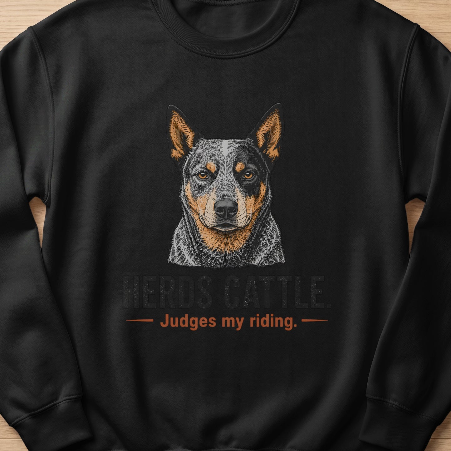 Black sweatshirt with an Australian Cattle Dog portrait and text "HERDS CATTLE. Judges my riding."