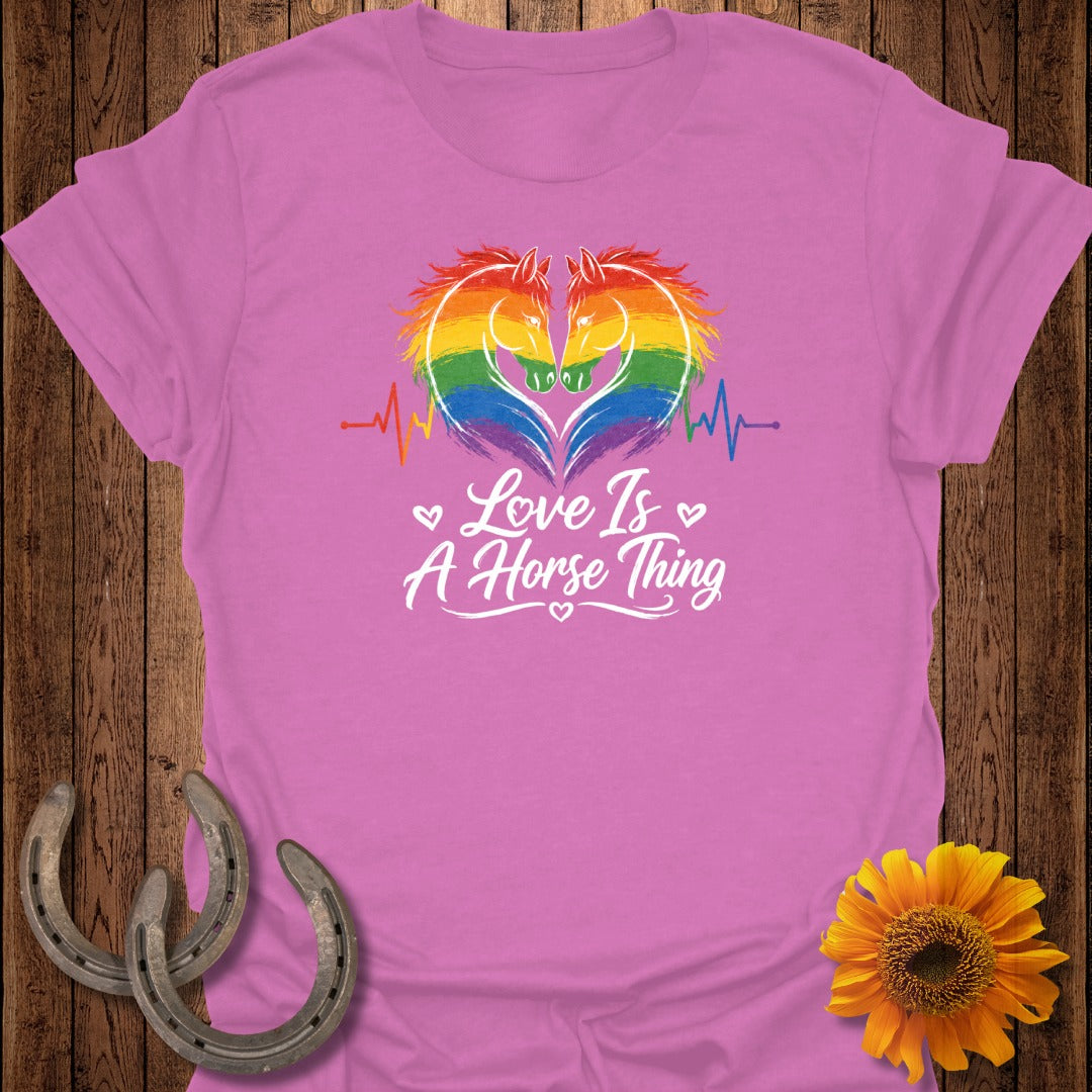 Pink t-shirt with rainbow horse heart graphic and "Love Is A Horse Thing" text.