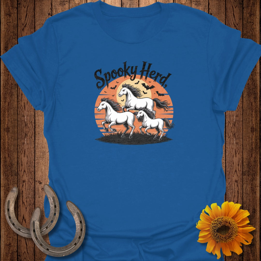 Three white horses gallop before an orange sunset with bats and text that says "Spooky Herd."