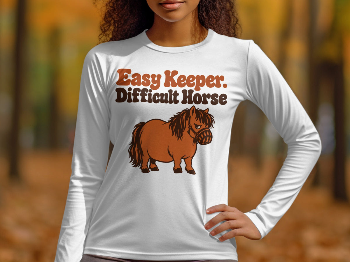 White long-sleeve shirt with "Easy Keeper. Difficult Horse" and a cartoon horse graphic.