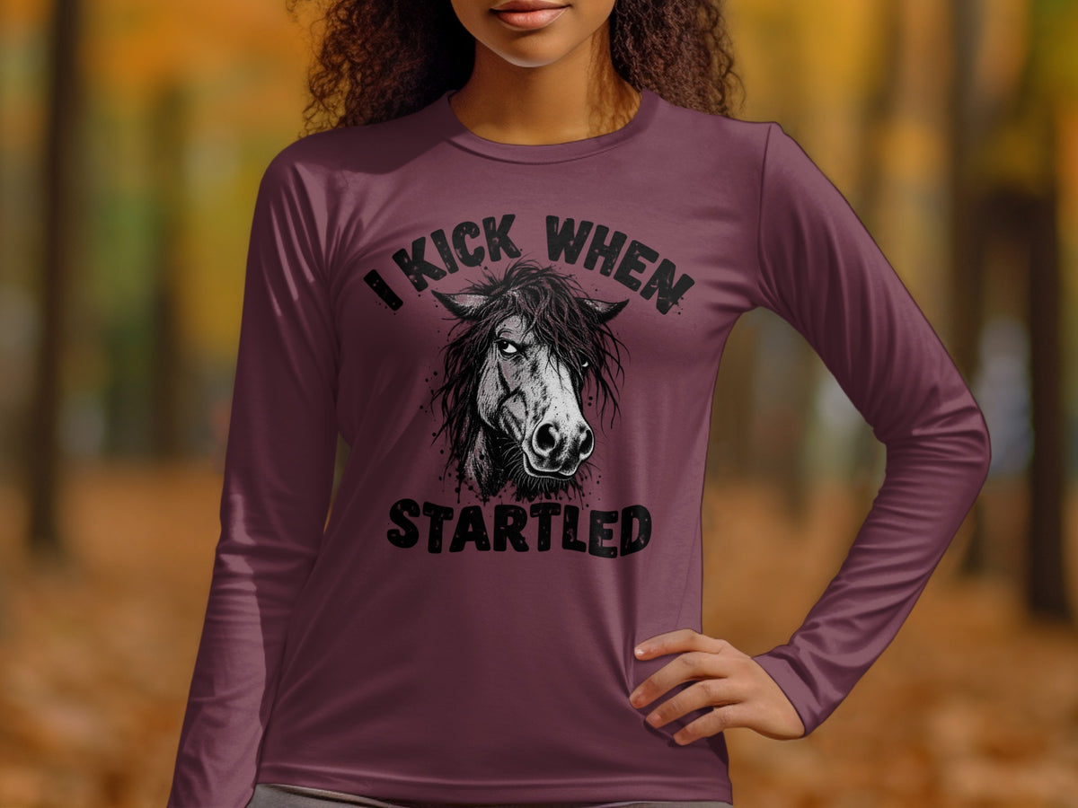 Long sleeve shirt with "I Kick When Startled" and horse graphic.