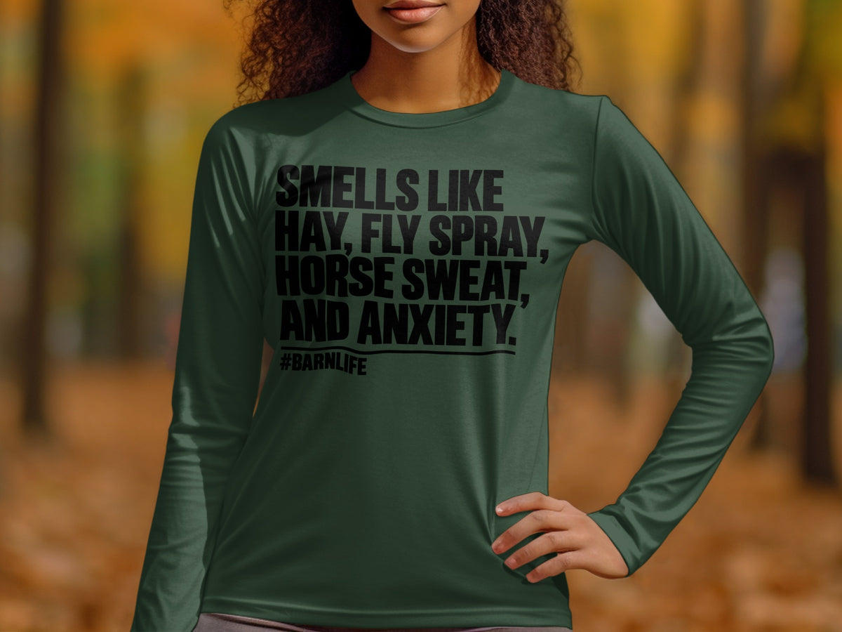 Green long-sleeve shirt with "Smells like hay, fly spray, horse sweat, and anxiety. #BARNLIFE" text.