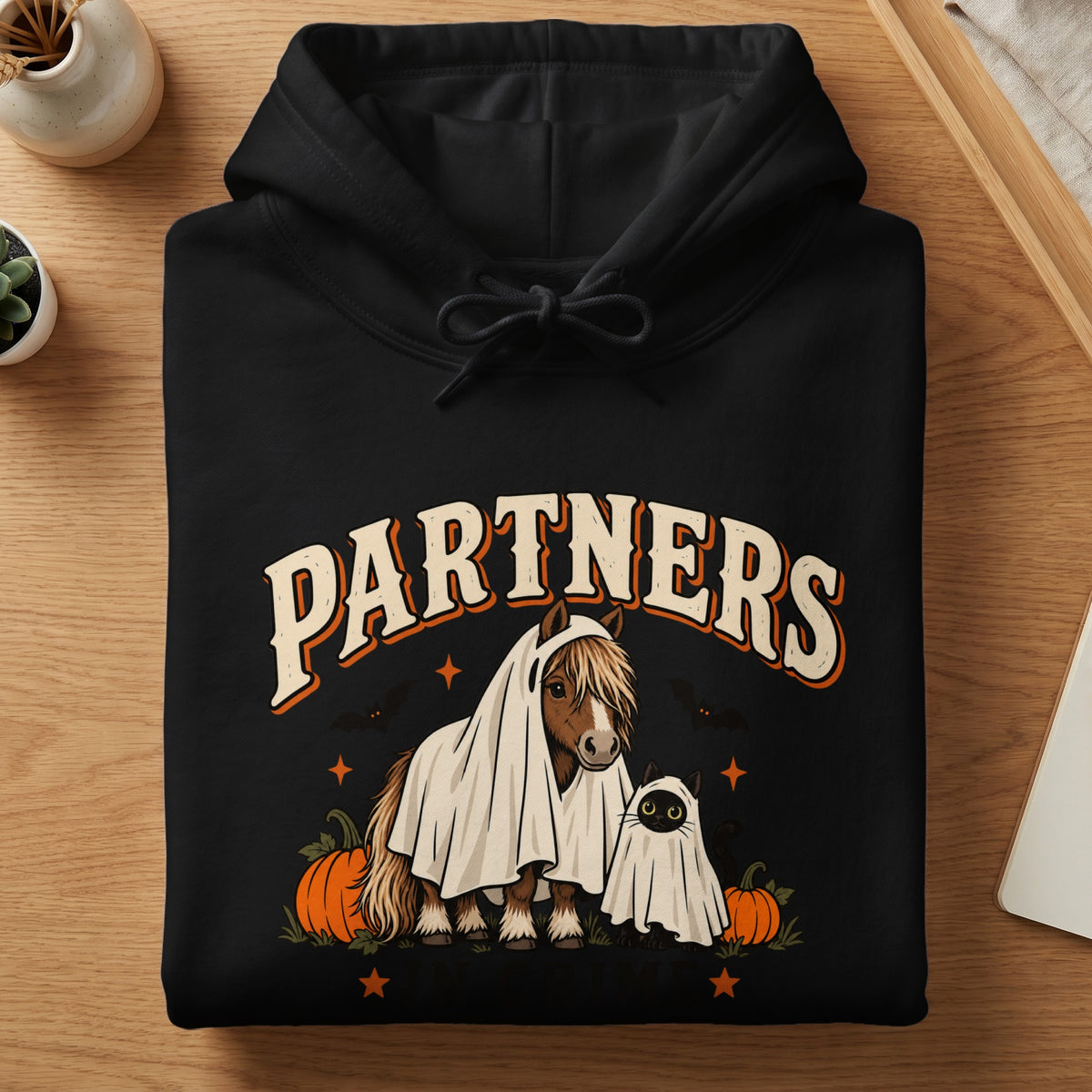 Black hoodie with "PARTNERS" text above horse and cat dressed as ghosts.