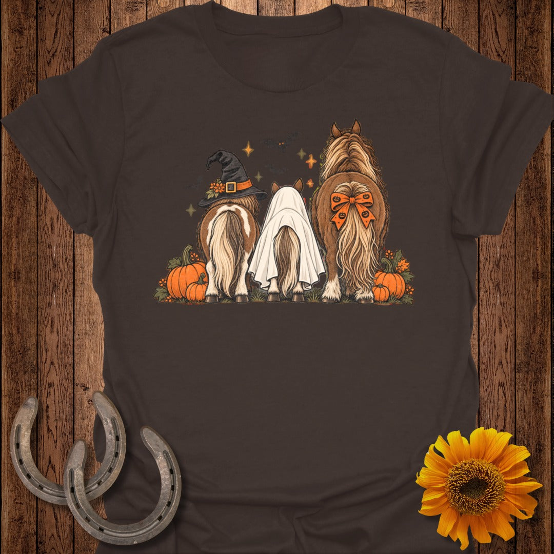 Three horses, one in a witch hat, one as a ghost, one with bow.