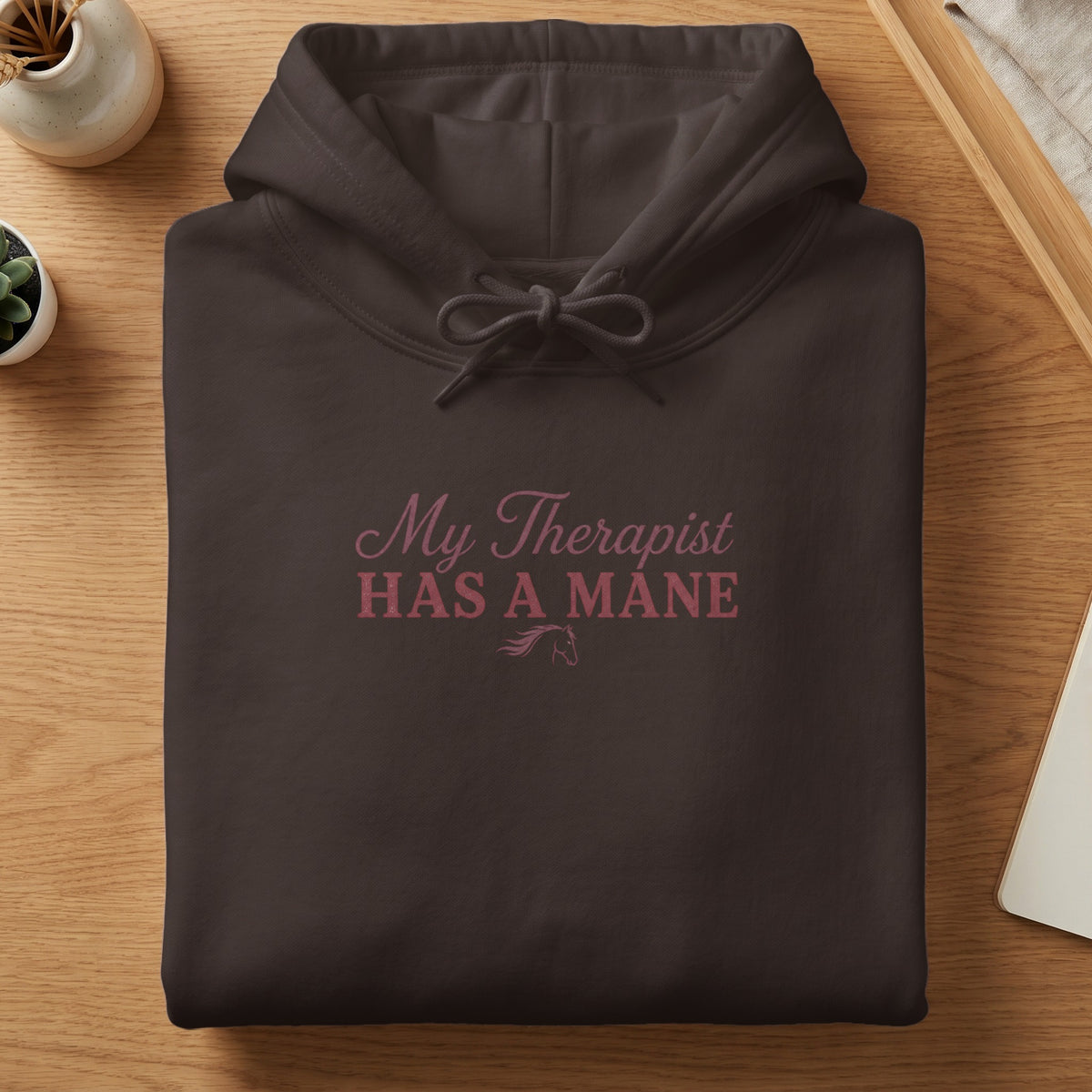 Dark brown hooded sweatshirt with pink text "My Therapist HAS A MANE" and horse graphic.