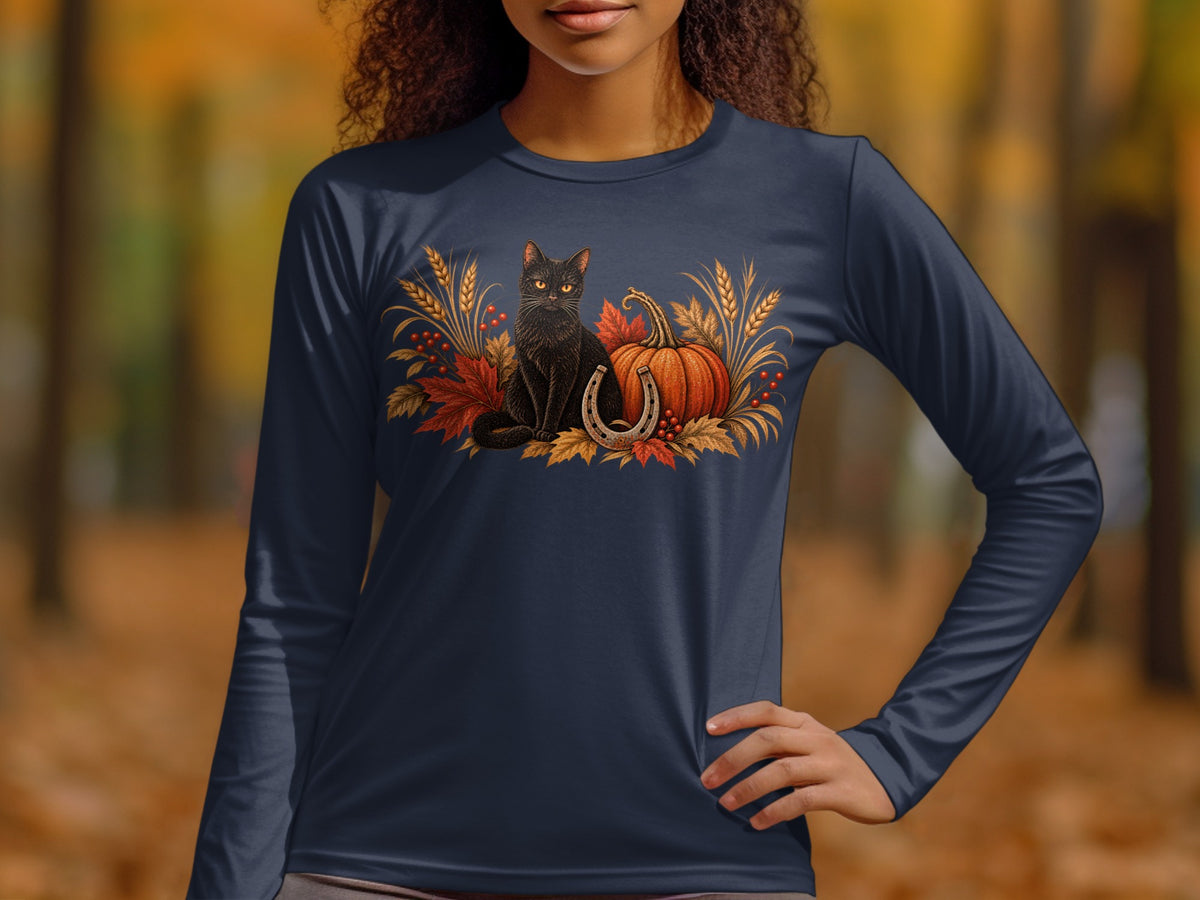 Black cat, pumpkin, horseshoe, and autumn leaves graphic on a navy long-sleeve shirt.