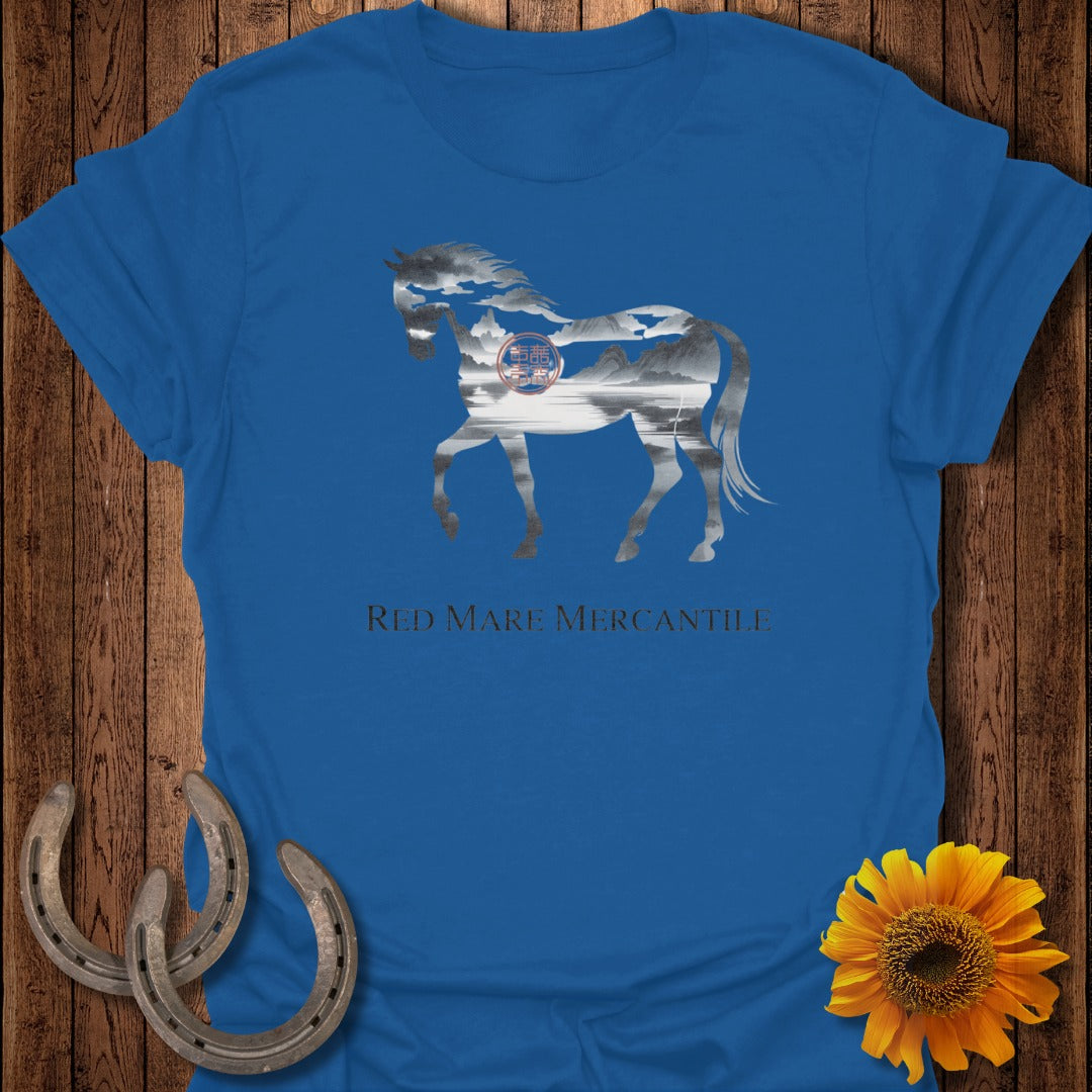 Blue t-shirt with a horse silhouette filled with a landscape and mountains.