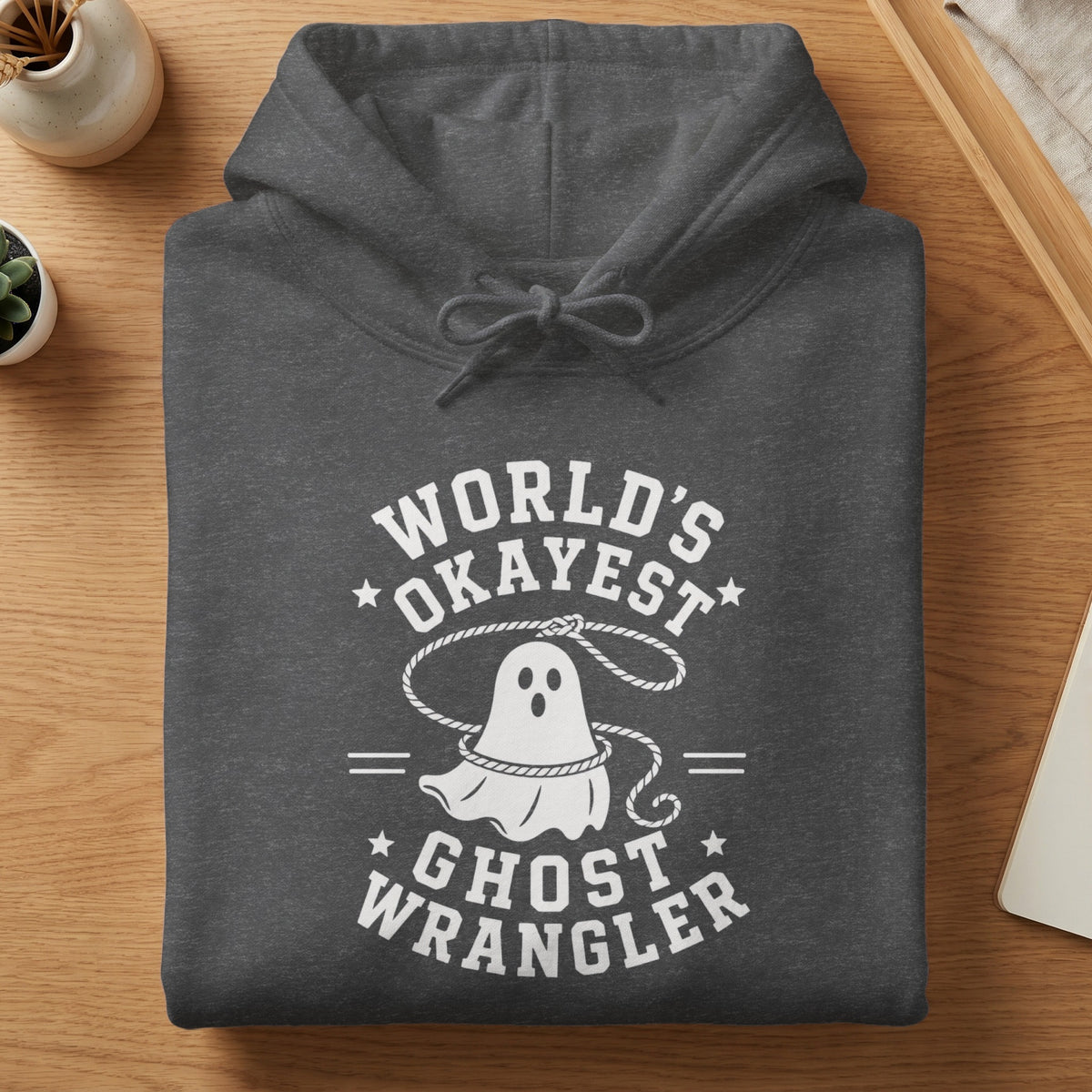 Dark gray hoodie with white "World's Okayest Ghost Wrangler" text and graphic.