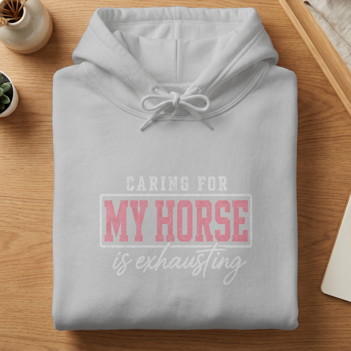 White hoodie with "CARING FOR MY HORSE is exhausting" text.