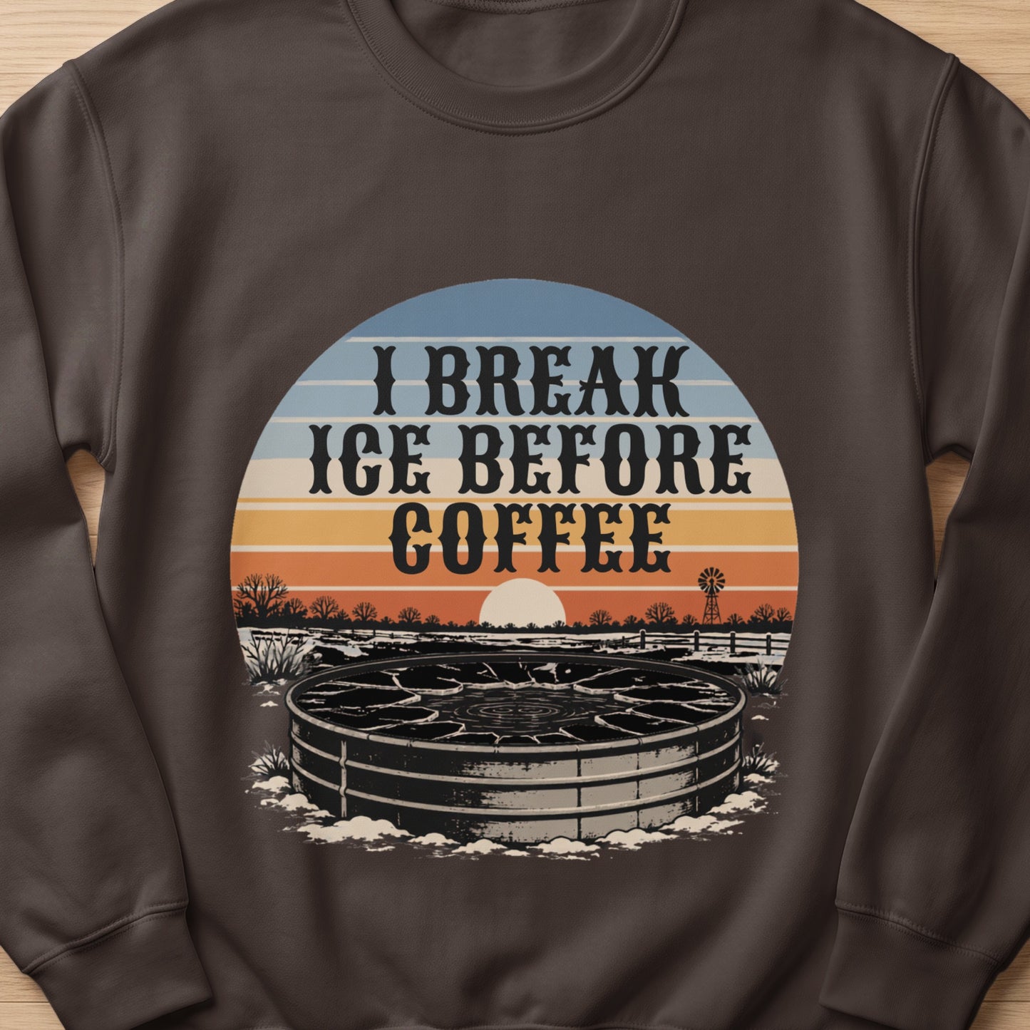 "I Break Ice Before Coffee" text over a stock tank with a sunset and windmill scene.