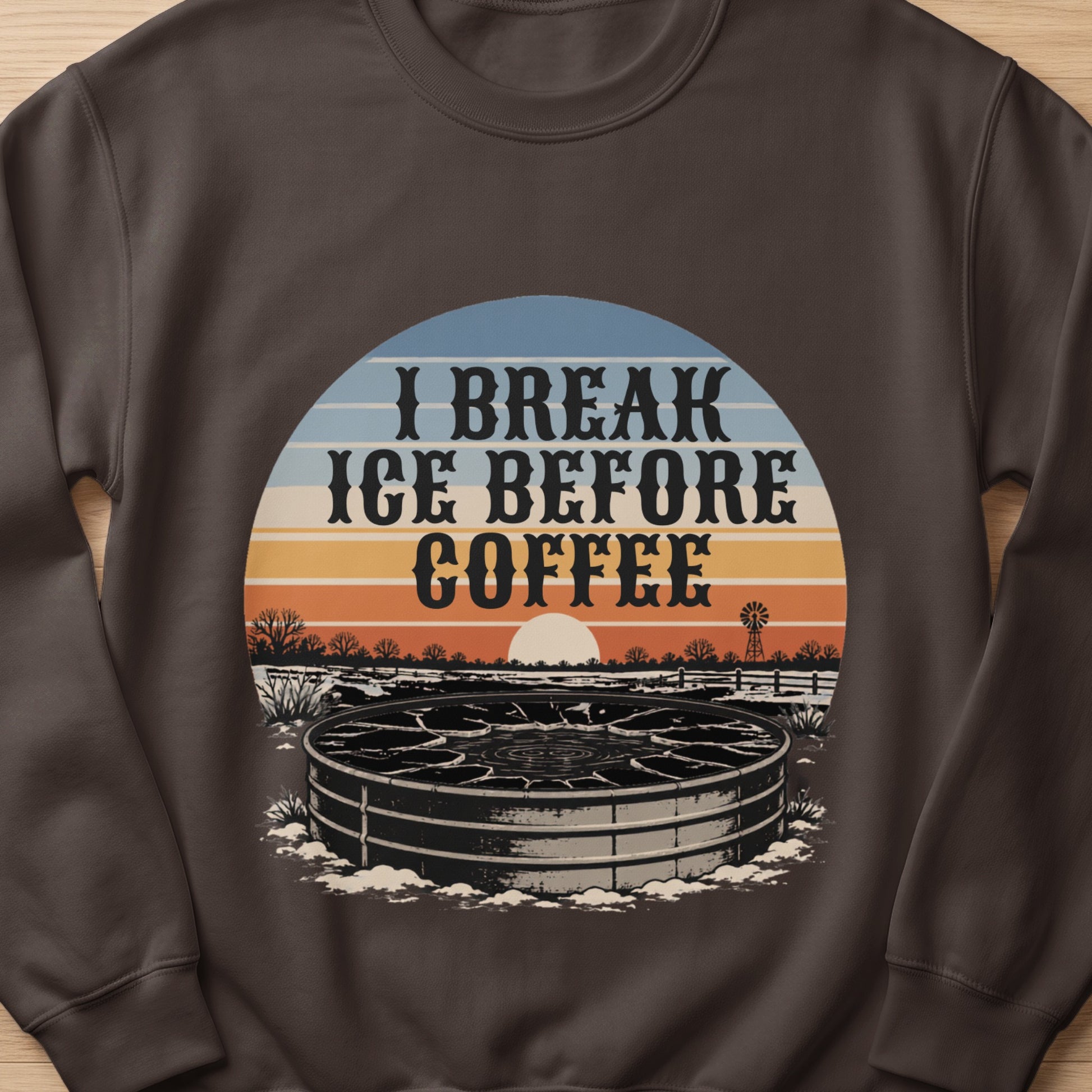 "I Break Ice Before Coffee" text over a stock tank with a sunset and windmill scene.