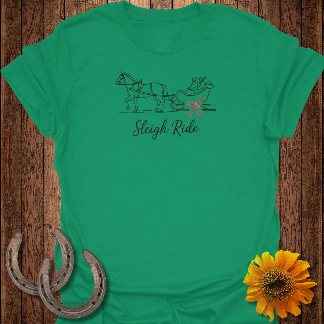 Green t-shirt with a line drawing of a horse pulling a sleigh with two people and holly.