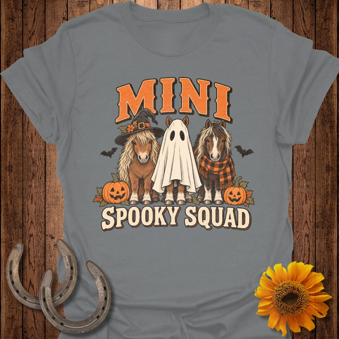 Three mini horses, one in a witch hat, one as a ghost, with pumpkins and bats.