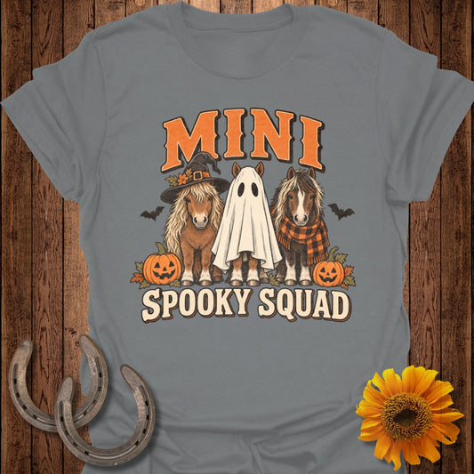 Three mini horses, one in a witch hat, one as a ghost, with pumpkins and bats.