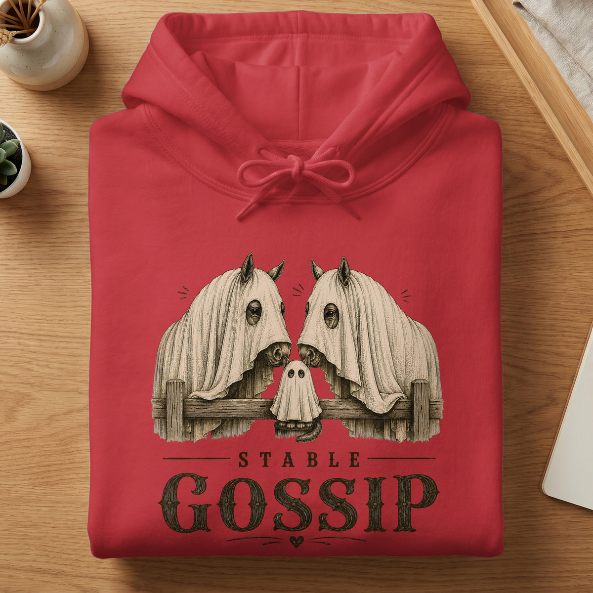 Red hoodie with "Stable Gossip" text and two horses covered in sheets.