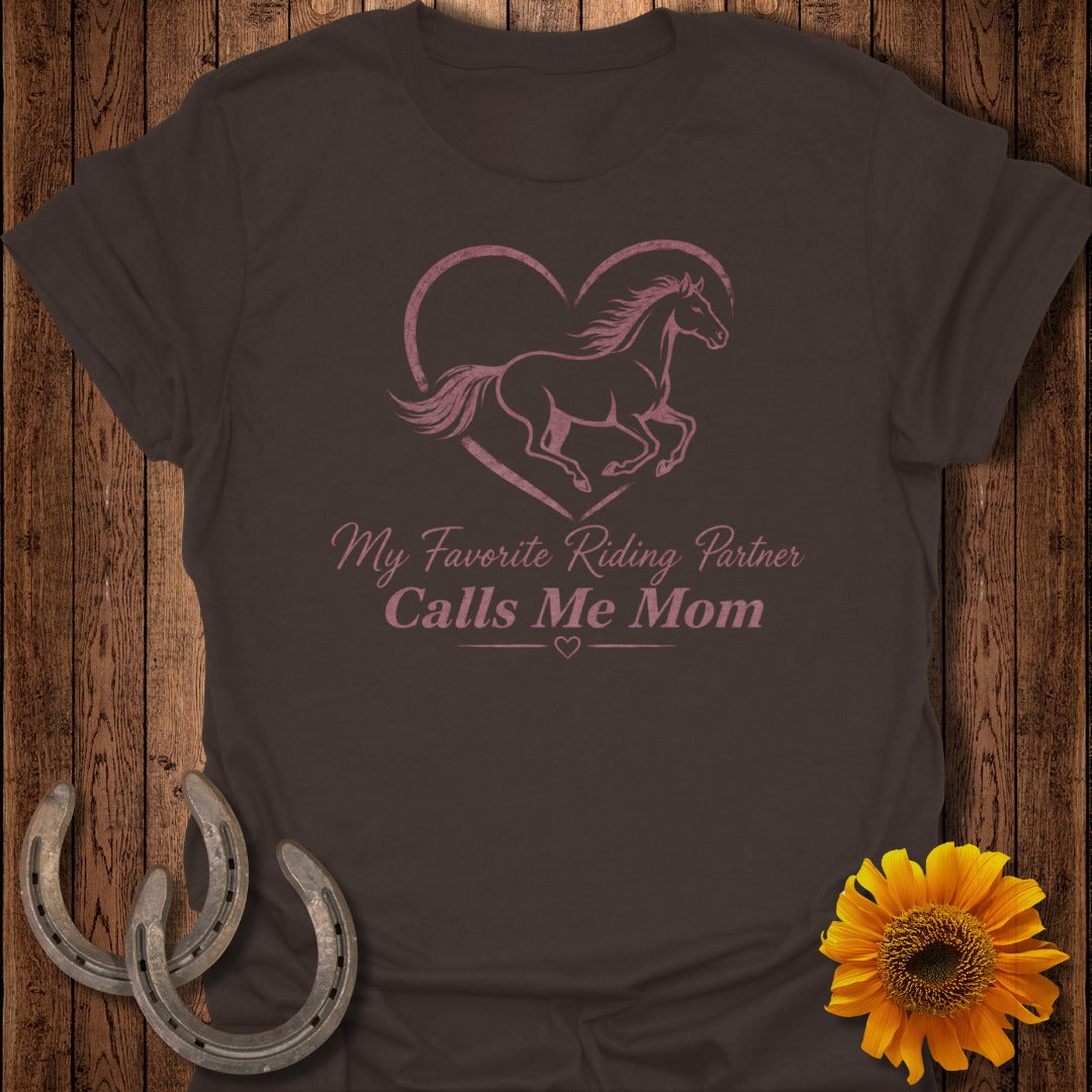 Brown t-shirt with pink horse inside a heart and text "My Favorite Riding Partner Calls Me Mom".