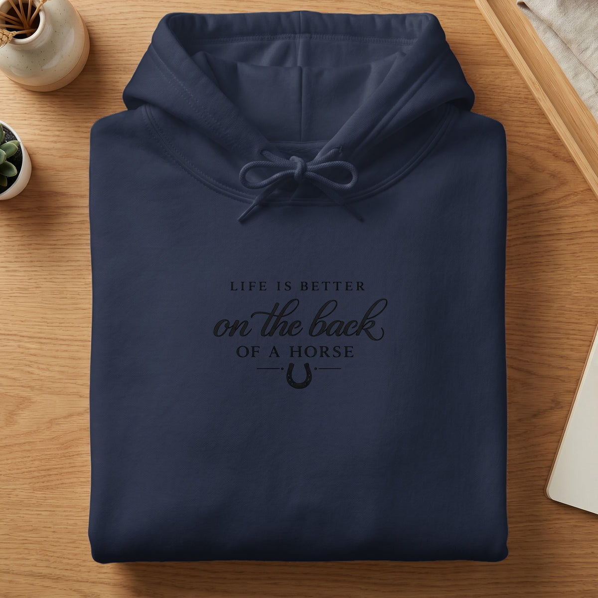 Navy blue hoodie with "Life is better on the back of a horse" text.