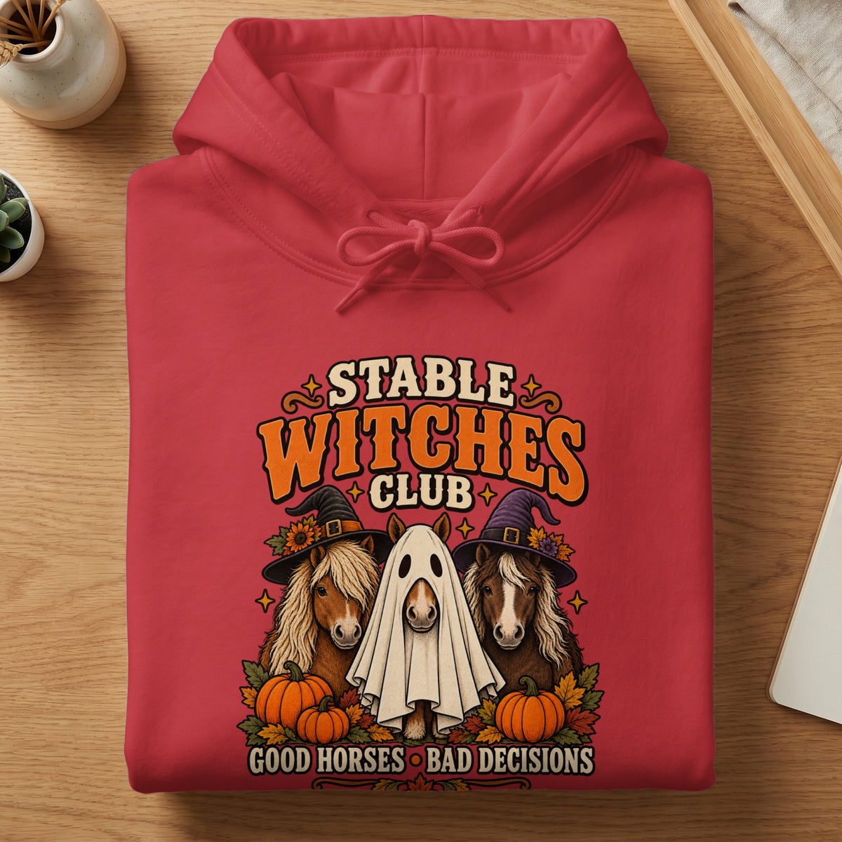 Red hoodie with "Stable Witches Club" graphic featuring horses, pumpkins, and Halloween text.