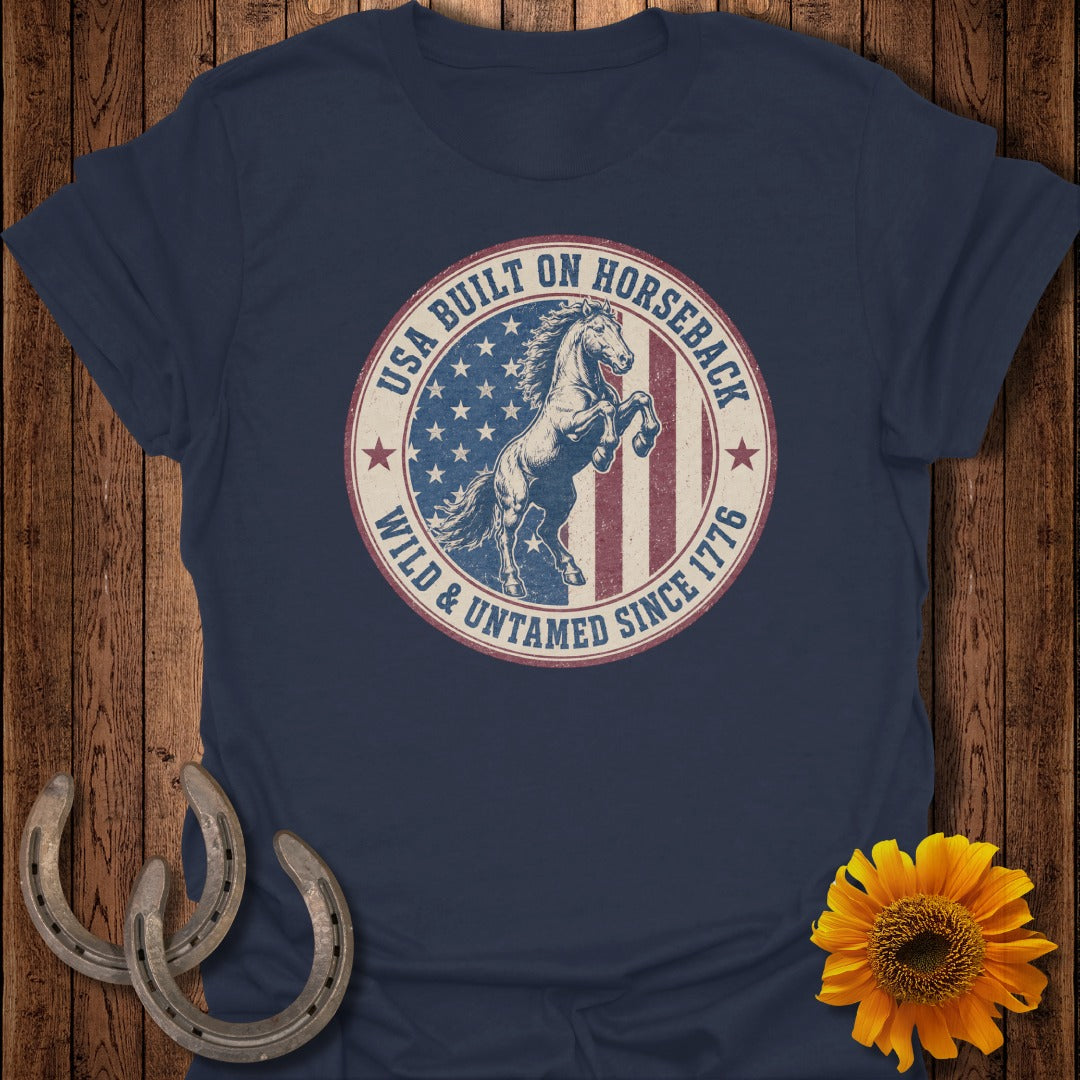 Navy t-shirt with vintage circle graphic of a rearing horse and American flag with text.
