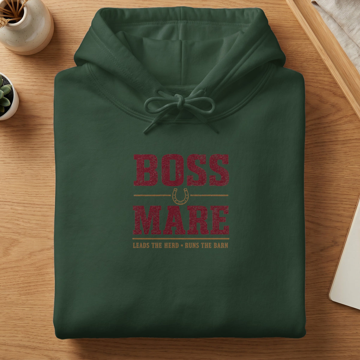 Dark green hoodie with "Boss Mare" text and horseshoe graphic.