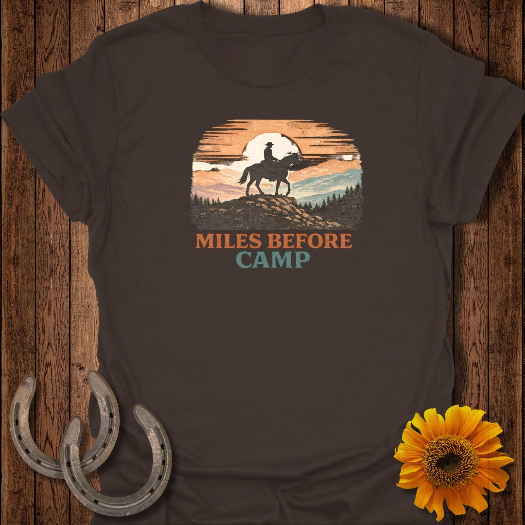 Brown t-shirt with vintage sunset graphic featuring a horse and rider and text "MILES BEFORE CAMP".