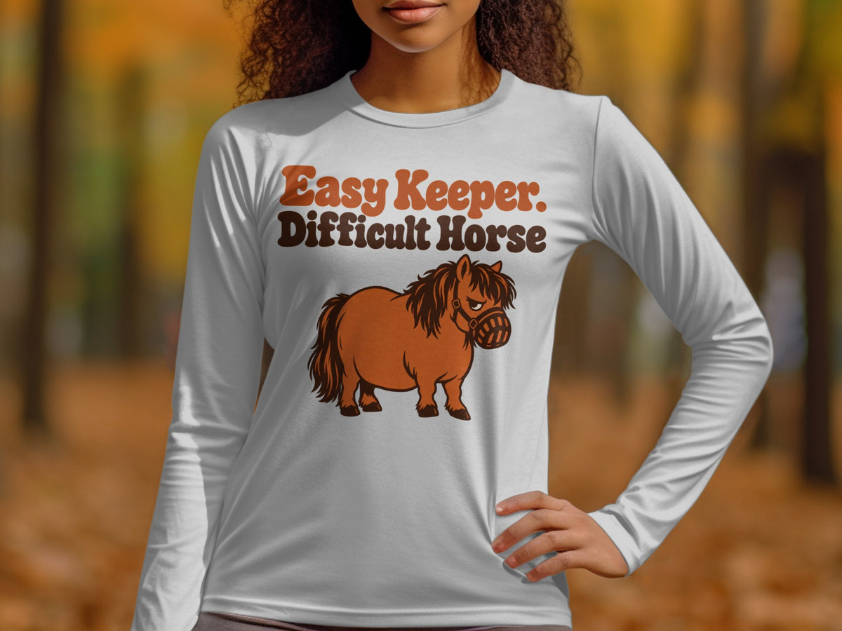 White long-sleeve shirt with "Easy Keeper. Difficult Horse" and cartoon horse graphic.