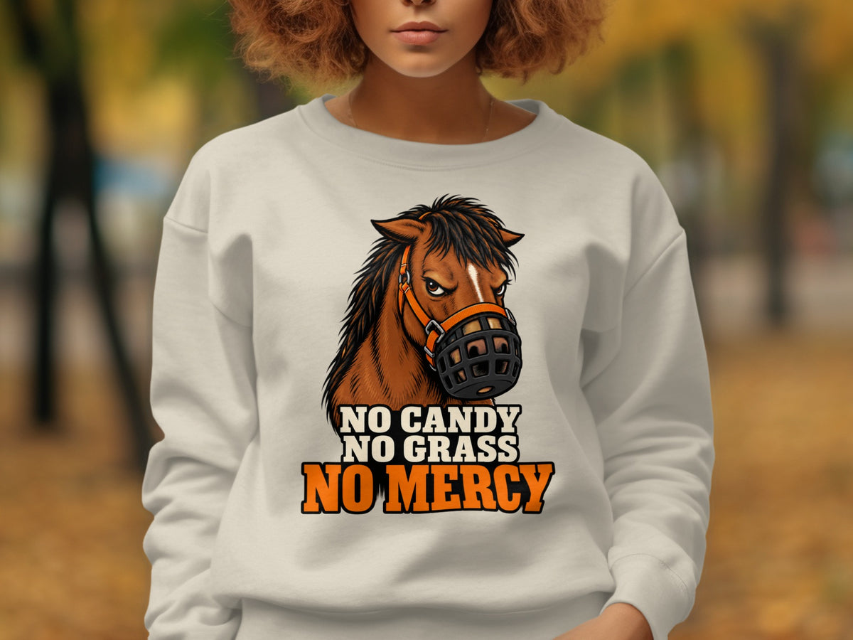 White sweatshirt with a brown horse wearing a muzzle, text "NO CANDY NO GRASS NO MERCY".