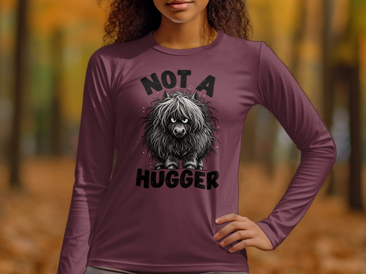 Long sleeve shirt with "NOT A HUGGER" text and a fluffy cow graphic.