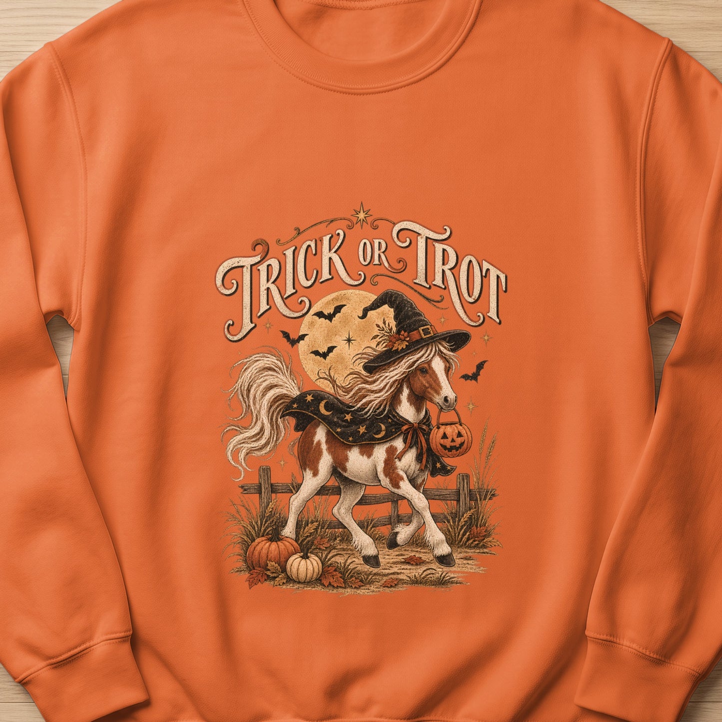 Horse in witch hat with pumpkin trick or trot text and Halloween elements.