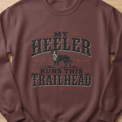 Brown sweatshirt with "MY HEELER RUNS THIS TRAILHEAD" text and dog graphic.