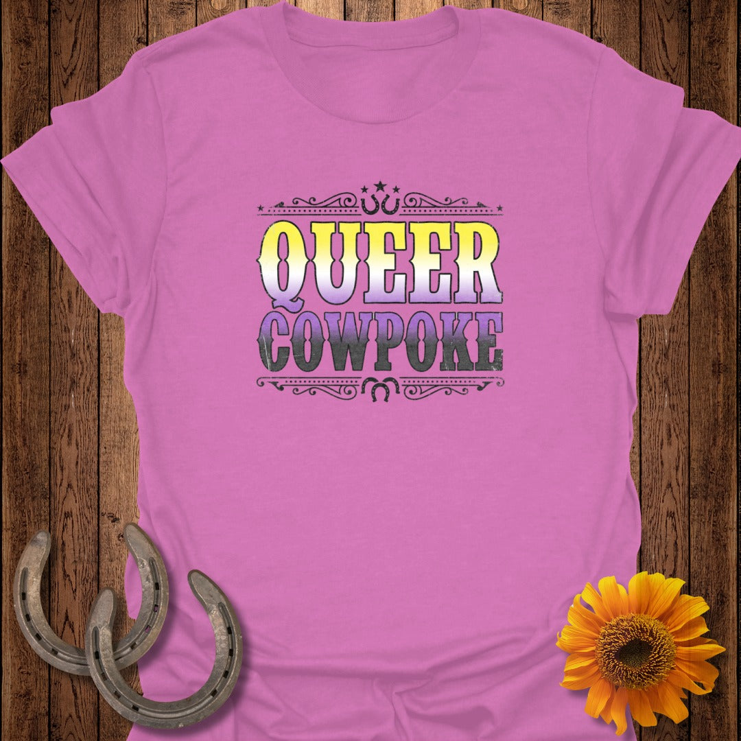 Pink t-shirt with "Queer Cowpoke" text in purple, yellow, and white.