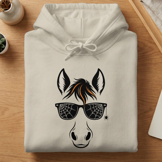 Cream hoodie with black horse face graphic and spiderweb sunglasses.