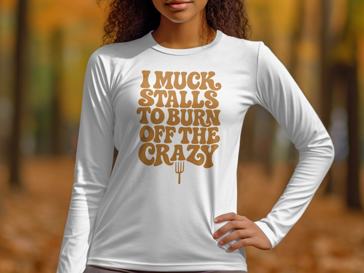 White long-sleeve shirt with "I muck stalls to burn off the crazy" text.