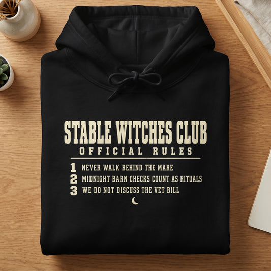 Black hoodie with "Stable Witches Club Official Rules" and three numbered rules.