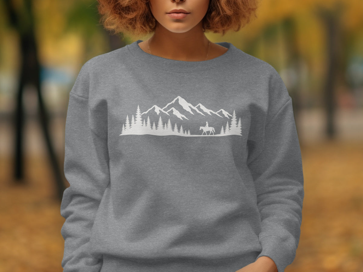 Gray sweatshirt with white mountain, tree, and horseback rider graphic.