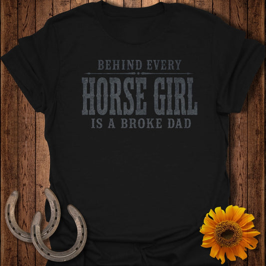 Black t-shirt with text "Behind every horse girl is a broke dad".