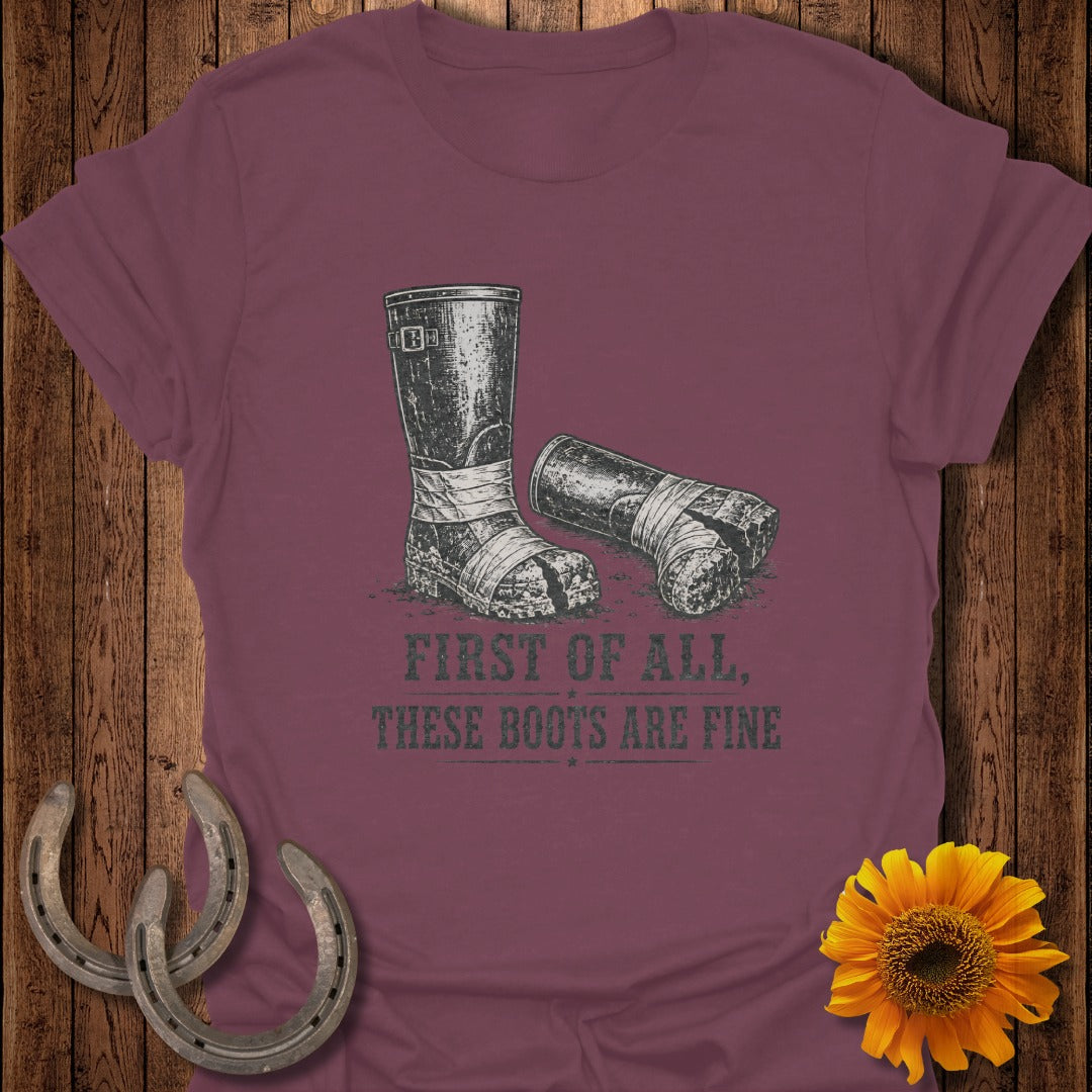 A maroon t-shirt with a graphic of worn boots and text.