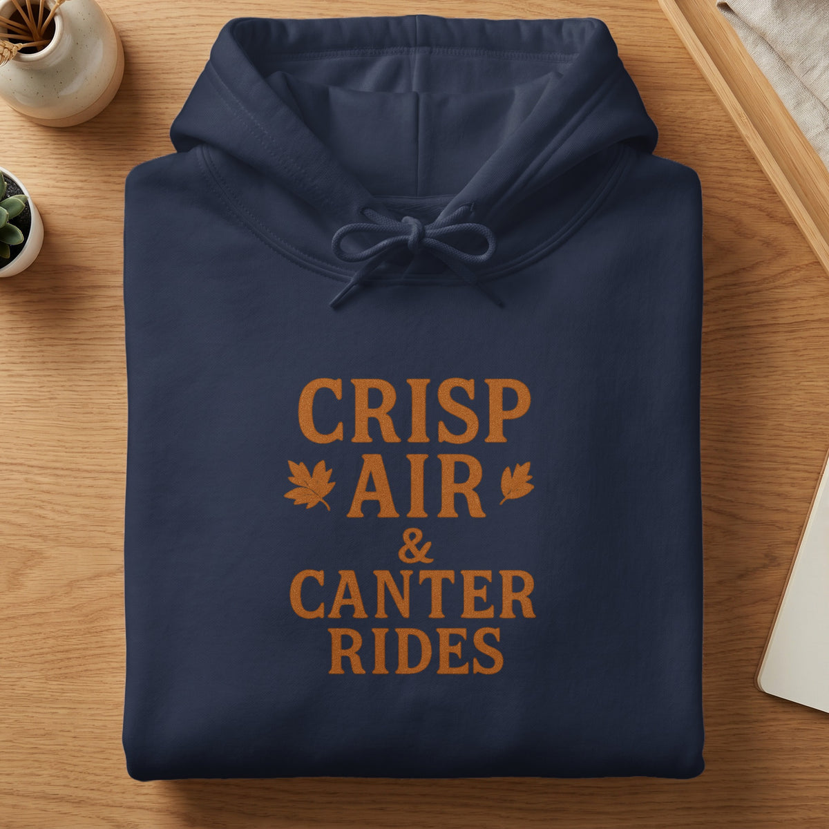 Navy blue hoodie with "CRISP AIR & CANTER RIDES" text and leaf graphics.