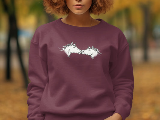 Maroon sweatshirt with white outline drawing of two horses facing each other.