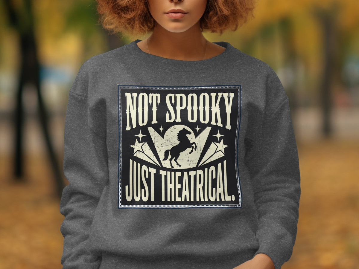 Gray sweatshirt with "Not Spooky Just Theatrical" text and a silhouette of a horse.