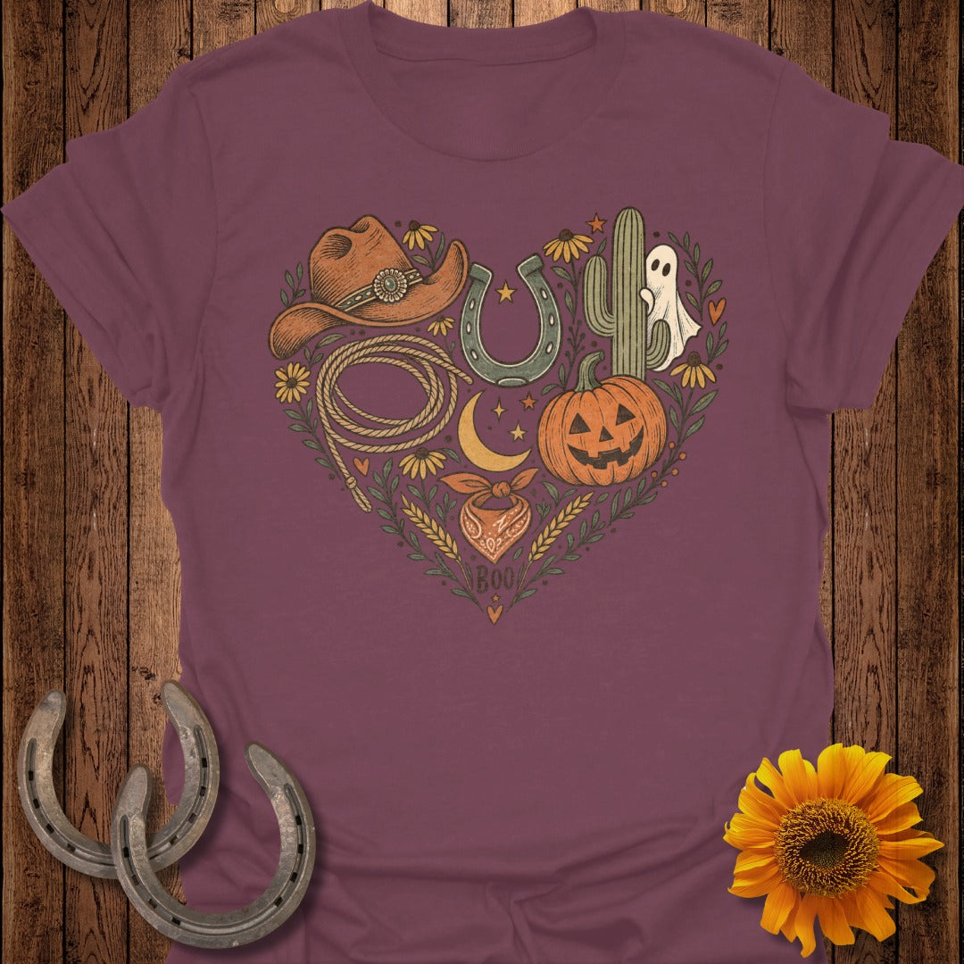 Heart graphic on maroon t-shirt with cowboy hat, lasso, horseshoe, cactus, pumpkin, ghost, and bandana.