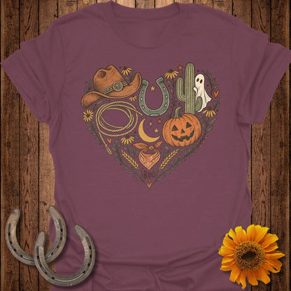 Heart graphic on maroon t-shirt with cowboy hat, lasso, horseshoe, cactus, pumpkin, ghost, and bandana.