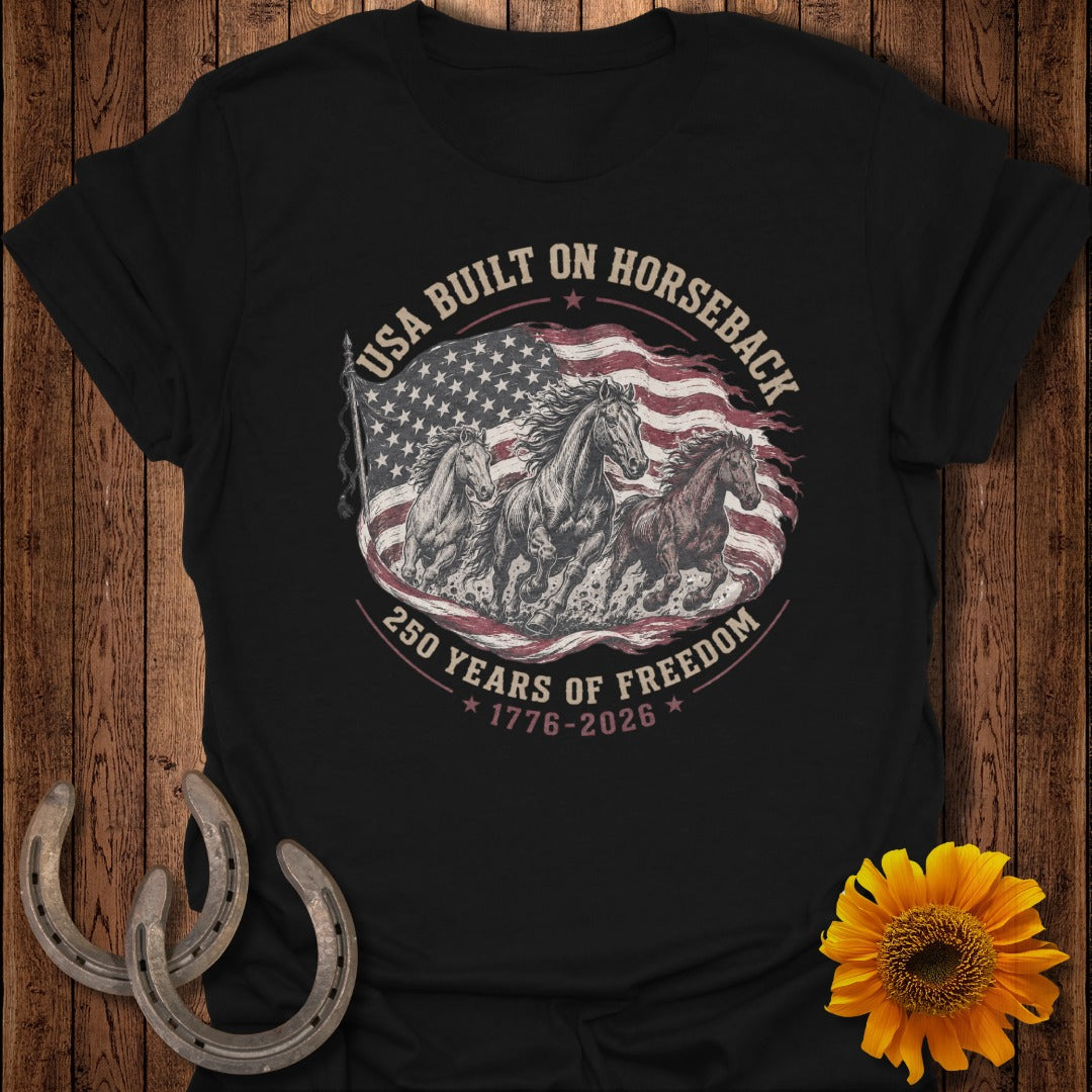 Black t-shirt with horses and American flag graphic, text reads "USA Built on Horseback 250 Years of Freedom".