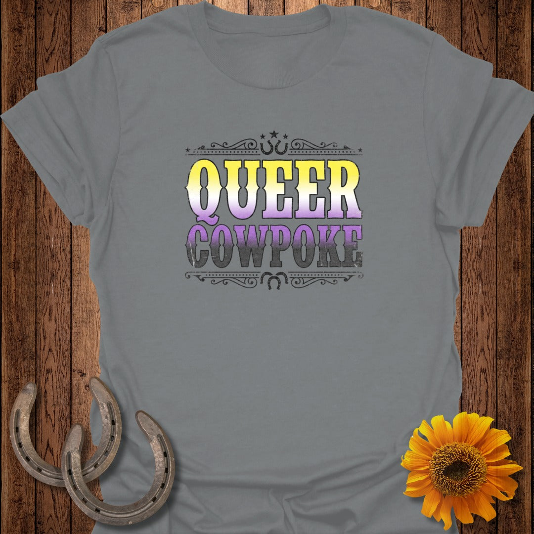 Grey t-shirt with "QUEER COWPOKE" in distressed purple and yellow lettering.