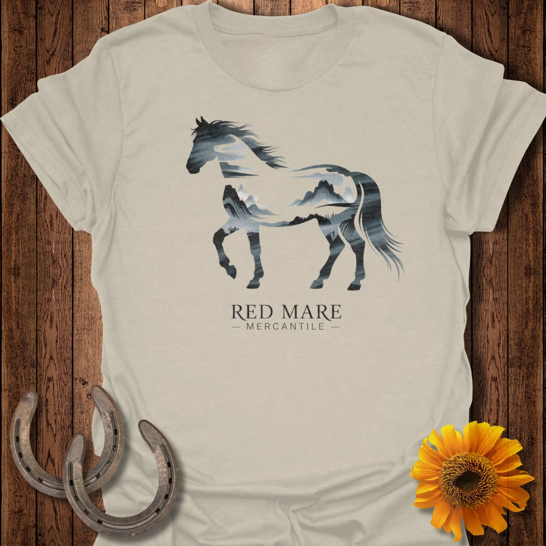 T-shirt with silhouette of horse filled with mountain landscape, "Red Mare Mercantile" text.