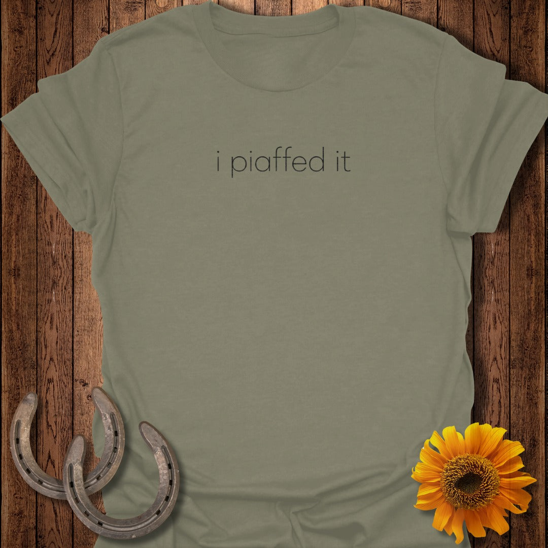 Olive green t-shirt with text "i piaffed it", horseshoes and sunflower decor.