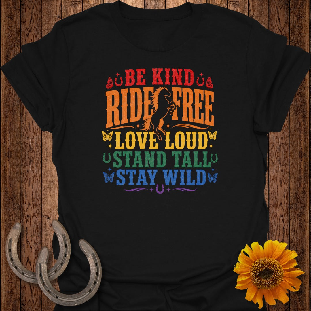 Black t-shirt with rainbow text "Be Kind, Ride Free, Love Loud, Stand Tall, Stay Wild" and horse graphic.
